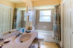 The guest bathroom serves as a pool bath and is meant to be shared between guest bedroom two and three
